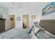 Serene main bedroom showcasing coastal decor, bedside tables, and access to an ensuite bathroom and closet at 10802 Seasons Way, Palmetto, FL 34221
