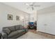 Bright home office area includes a gray couch, desk, and plenty of storage inside of a built-in closet at 10802 Seasons Way, Palmetto, FL 34221