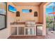 Outdoor kitchen with stainless steel appliances, a built-in grill, and a granite countertop at 10802 Seasons Way, Palmetto, FL 34221