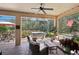 Relaxing screened-in patio with comfortable seating and an inviting hot tub in the background at 10802 Seasons Way, Palmetto, FL 34221