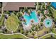 Overhead shot of the community's swimming pool, surrounded by palm trees, lounge chairs, and manicured landscaping at 10802 Seasons Way, Palmetto, FL 34221