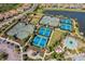 Aerial view of multiple well-maintained tennis courts, swimming pool, and recreational area in a residential community at 10802 Seasons Way, Palmetto, FL 34221