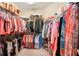 Spacious walk-in closet with ample storage and well-organized clothing racks at 10802 Seasons Way, Palmetto, FL 34221