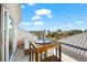 Beautiful balcony with stylish outdoor furniture, offering a stunning view of the city skyline and blue skies at 116 Garden Ln, Sarasota, FL 34242