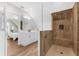 Bathroom featuring a dual sink vanity, and a glass-enclosed shower with stylish tile and a built-in bench at 116 Garden Ln, Sarasota, FL 34242
