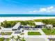 Panoramic view of Siesta Key Beach with clear blue waters, soft white sand, and swaying palm trees at 116 Garden Ln, Sarasota, FL 34242