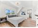 Bright bedroom features natural light, wood floors, and stylish decor at 116 Garden Ln, Sarasota, FL 34242