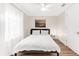 This is a simple yet elegant bedroom with a queen bed, wood floors, and a nautical theme at 116 Garden Ln, Sarasota, FL 34242