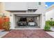 Spacious two-car garage showcasing a Porsche and G-Wagon at 116 Garden Ln, Sarasota, FL 34242