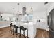 Bright kitchen with white cabinets, marble countertops, a center island with seating, and stainless steel appliances at 116 Garden Ln, Sarasota, FL 34242