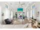 Bright living room featuring a coffered ceiling, fan, and access to an outdoor seating area, perfect for entertaining or relaxing at 116 Garden Ln, Sarasota, FL 34242