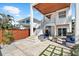 Outdoor patio with blue furniture and a modern staircase at 116 Garden Ln, Sarasota, FL 34242