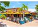 Vibrant restaurant featuring outdoor seating, yellow umbrellas, and barrel accents at 116 Garden Ln, Sarasota, FL 34242