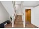 The staircase boasts wood treads and a convenient elevator access, creating a blend of classic design and modern accessibility at 116 Garden Ln, Sarasota, FL 34242