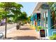 Charming street view with trees and small business, including Gidget's Coastal Provisions at 116 Garden Ln, Sarasota, FL 34242