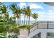 Scenic water view with palm trees, blue sky, clear water, and access to a staircase at 116 Garden Ln, Sarasota, FL 34242