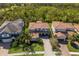 Aerial view of a beautiful residential neighborhood showcases lush landscaping and a terra cotta roof at 12022 Medley Ter, Lakewood Ranch, FL 34211