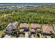 Aerial view of two-story homes with clay tile roofs in a neatly landscaped neighborhood with a blue sky in the background at 12022 Medley Ter, Lakewood Ranch, FL 34211
