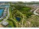 Aerial view of the community park, featuring walking paths, lush landscaping, and beautiful water features at 12022 Medley Ter, Lakewood Ranch, FL 34211