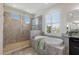 Spa-like bathroom featuring a large glass shower and garden tub at 12022 Medley Ter, Lakewood Ranch, FL 34211