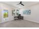 Well lit bedroom with a ceiling fan, neutral carpet, and view to balcony at 12022 Medley Ter, Lakewood Ranch, FL 34211