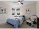 Cozy bedroom with a ceiling fan, two windows and light blue bedspread and accent pillows, plus matching wall decor at 12022 Medley Ter, Lakewood Ranch, FL 34211