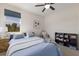 Bright bedroom with large window, comfy bed, ceiling fan, and a bookshelf in the corner at 12022 Medley Ter, Lakewood Ranch, FL 34211