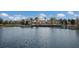 A lakefront community clubhouse with umbrellas and seating next to a lake at 12022 Medley Ter, Lakewood Ranch, FL 34211