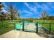 Community dog park with secure fencing and pond access, designed for pet owners and their furry friends at 12022 Medley Ter, Lakewood Ranch, FL 34211