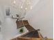 Elegant foyer showcasing a chandelier, staircase with wood treads, and decorative front door at 12022 Medley Ter, Lakewood Ranch, FL 34211