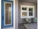 Inviting front porch with a decorative front door, seating, and stylish brick flooring at 12022 Medley Ter, Lakewood Ranch, FL 34211