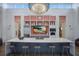 Stylish kitchen with a large island, stainless steel appliances, and open shelving for a modern and functional space at 12022 Medley Ter, Lakewood Ranch, FL 34211