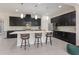 Stunning kitchen with dark cabinets, a large island, pendant lighting, and stainless steel appliances at 12022 Medley Ter, Lakewood Ranch, FL 34211
