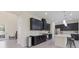 Modern kitchen with stainless steel appliances, dark cabinets, and an island with bar stool seating at 12022 Medley Ter, Lakewood Ranch, FL 34211