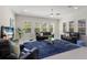 Bright living room with recessed lighting, ceiling fan, shuttered windows, and modern decor at 12022 Medley Ter, Lakewood Ranch, FL 34211