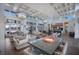 Open-concept living room with high ceilings, modern decor, a dining area and ample natural light from large windows at 12022 Medley Ter, Lakewood Ranch, FL 34211