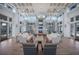 Bright living room featuring hardwood floors, large windows, and modern furnishings, with a fireplace as the focal point at 12022 Medley Ter, Lakewood Ranch, FL 34211