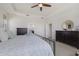 Spacious bedroom showcasing tray ceiling, neutral walls, and two dressers with an open entry to the bathroom at 12022 Medley Ter, Lakewood Ranch, FL 34211