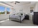 Spacious main bedroom featuring a ceiling fan, tray ceiling, and many windows at 12022 Medley Ter, Lakewood Ranch, FL 34211