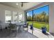 Screened patio with a table and chairs with a lush green lawn view at 12022 Medley Ter, Lakewood Ranch, FL 34211