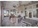 Inviting outdoor patio with a fireplace, comfortable seating, creating a cozy atmosphere for relaxation and entertaining at 12022 Medley Ter, Lakewood Ranch, FL 34211