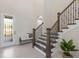 Beautiful staircase with dark wood and wrought iron near the entry with tiled floor at 12022 Medley Ter, Lakewood Ranch, FL 34211