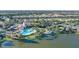 Aerial view of the community pool, clubhouse, and lake surrounded by palm trees and lush landscaping at 1239 Burgos Dr # 305, Sarasota, FL 34238