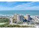 Aerial shot showcasing buildings near a beach, a coastal road, and water views at 1300 Benjamin Franklin Dr # 304, Sarasota, FL 34236