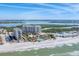 Stunning aerial view of beachfront condos with pools and beach access, offering luxurious coastal living and beautiful Gulf views at 1300 Benjamin Franklin Dr # 304, Sarasota, FL 34236