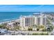 Gorgeous aerial view of a luxurious building near the beach, featuring coastal views and an oceanfront pool at 1300 Benjamin Franklin Dr # 304, Sarasota, FL 34236