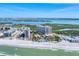 Aerial view of beachfront condos, swimming pool, and beach access with clear ocean views at 1300 Benjamin Franklin Dr # 304, Sarasota, FL 34236