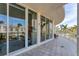 Spacious curved balcony overlooking city views, featuring gray tile flooring at 1300 Benjamin Franklin Dr # 304, Sarasota, FL 34236