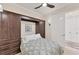 Comfortable bedroom featuring a built-in wardrobe, murphy bed and ceiling fan at 1300 Benjamin Franklin Dr # 304, Sarasota, FL 34236