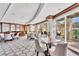 An inviting clubhouse with a bar, stylish seating, and serene outdoor views through expansive glass doors at 1300 Benjamin Franklin Dr # 304, Sarasota, FL 34236
